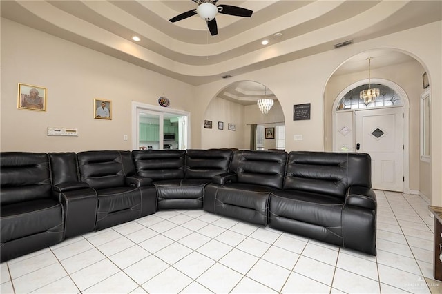 6800 N 35th St, Mcallen, TX 78504 - home theater featuring a raised ceiling, arched walkways, ceiling fan with notable chandelier, light tile patterned floors, and visible vents