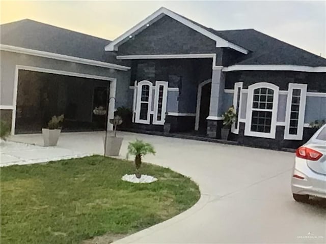 3403 Adare St, Weslaco, TX 78599 - view of front of house with a front yard, curved driveway, and stucco siding