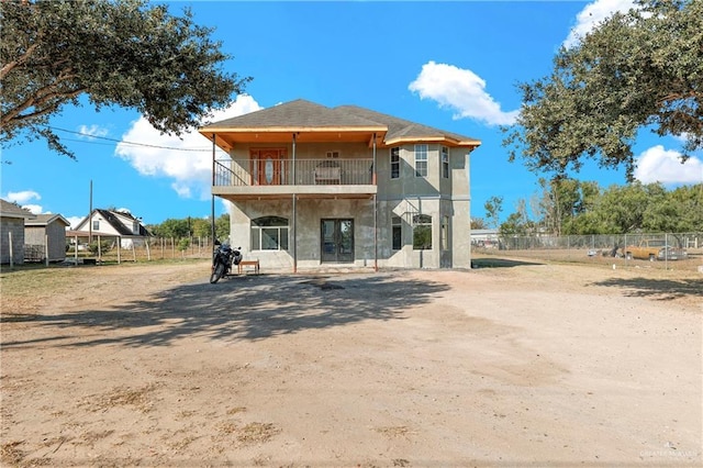 back of property with a balcony