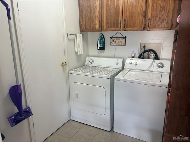 911 Santa Anna Dr, Alamo, TX 78516 - laundry room featuring separate washer and dryer, cabinet space, and light tile patterned flooring