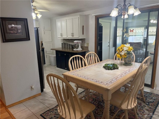 911 Santa Anna Dr, Alamo, TX 78516 - dining room featuring a chandelier, light tile patterned flooring, baseboards, and a ceiling fan