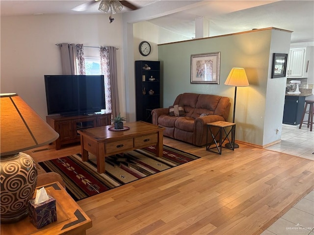 911 Santa Anna Dr, Alamo, TX 78516 - living room featuring ceiling fan, vaulted ceiling, wood finished floors, and baseboards