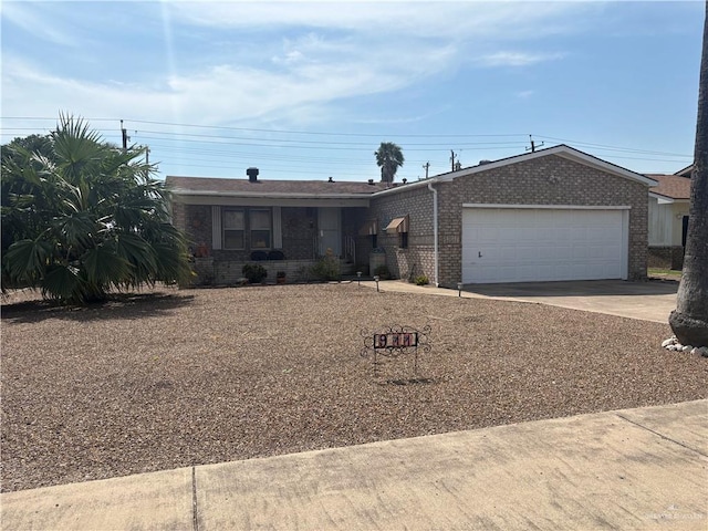 911 Santa Anna Dr, Alamo, TX 78516 - ranch-style house featuring a garage, brick siding, and driveway