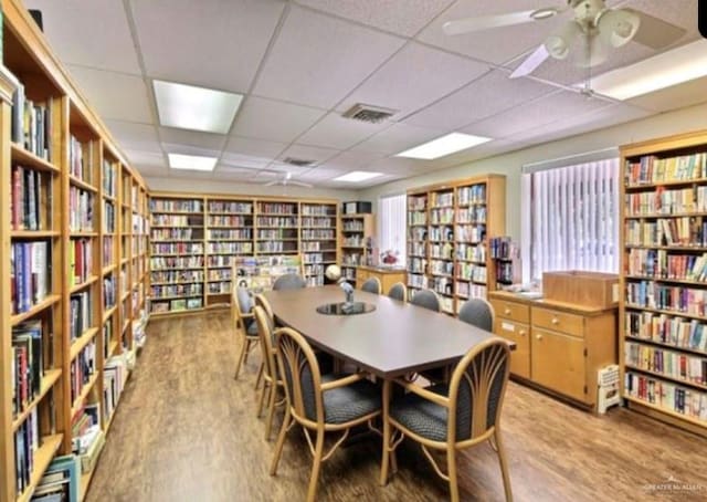 911 Santa Anna Dr, Alamo, TX 78516 - dining area featuring a drop ceiling, light wood-type flooring, and a ceiling fan