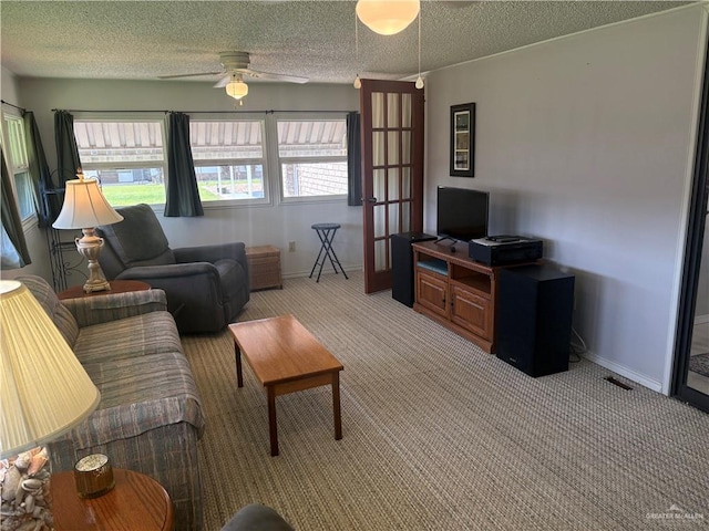 911 Santa Anna Dr, Alamo, TX 78516 - living room featuring light colored carpet, ceiling fan, a textured ceiling, and baseboards