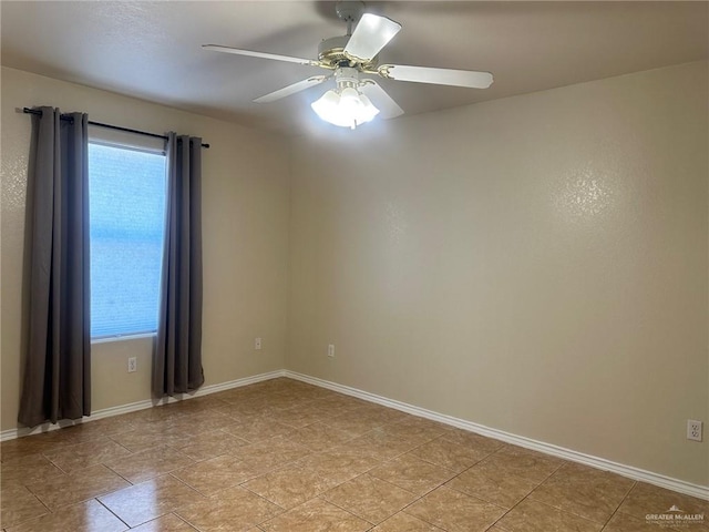 tiled empty room featuring ceiling fan