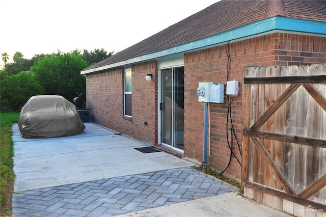 view of side of home featuring a patio area