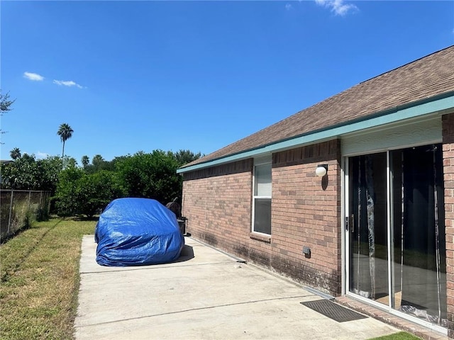 view of home's exterior with a lawn and a patio