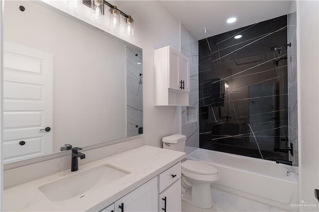 full bathroom featuring vanity, toilet, and tiled shower / bath