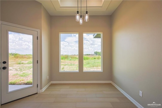 entryway with plenty of natural light and an inviting chandelier