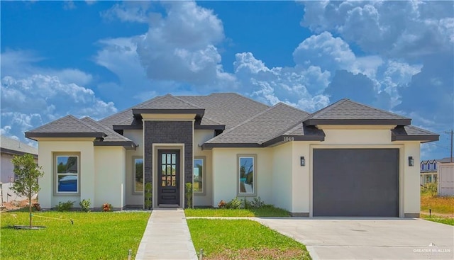 view of front of house with a garage and a front yard