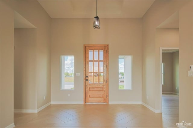 entrance foyer featuring a high ceiling and light parquet flooring