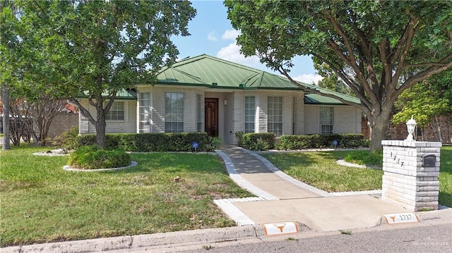 1717 Edward Dr, Edinburg, TX 78539 - ranch-style house featuring a front lawn, brick siding, metal roof, and a standing seam roof