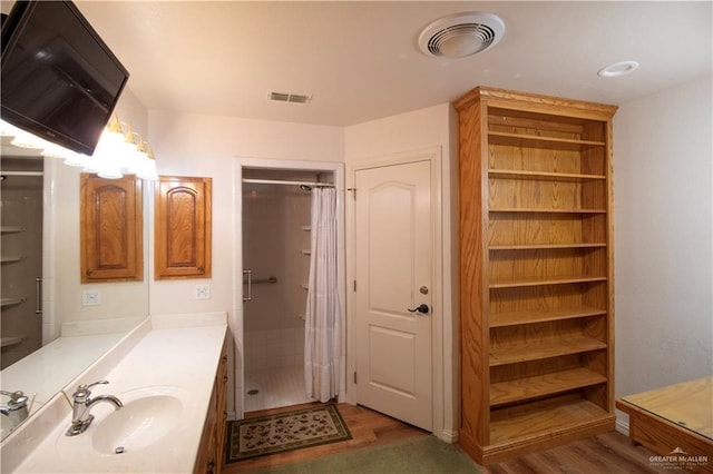 1717 Edward Dr, Edinburg, TX 78539 - bathroom with wood finished floors, a shower with curtain, and vanity