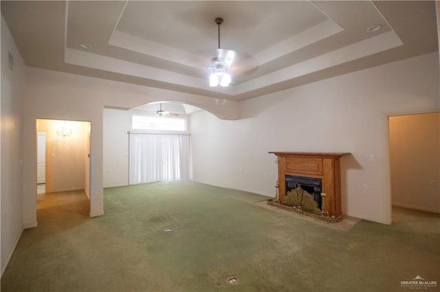 1717 Edward Dr, Edinburg, TX 78539 - unfurnished living room featuring ceiling fan, a raised ceiling, arched walkways, and carpet floors
