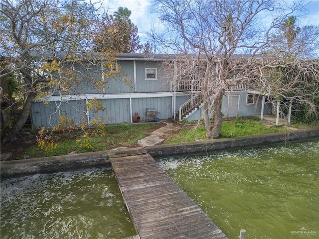 back of property with a water view