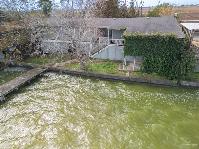 back of house featuring a water view