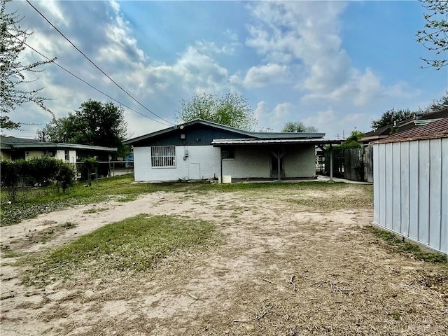 back of house featuring fence