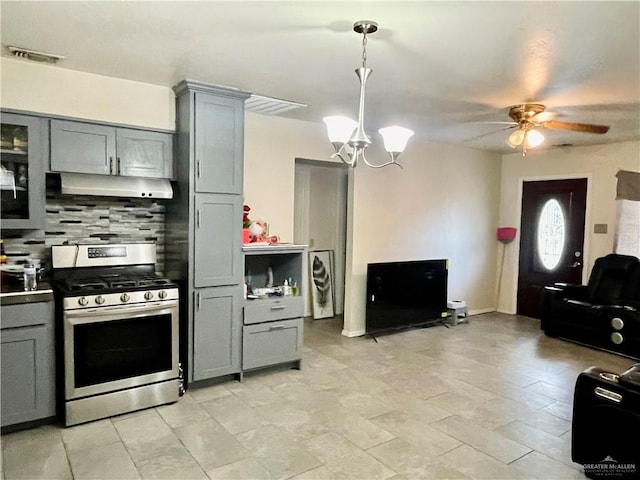 kitchen featuring gray cabinets, visible vents, backsplash, stainless steel gas range, and under cabinet range hood