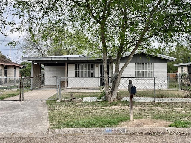 view of front of house featuring a fenced front yard, brick siding, concrete driveway, a gate, and a carport