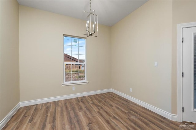 unfurnished dining area featuring dark hardwood / wood-style flooring and a notable chandelier