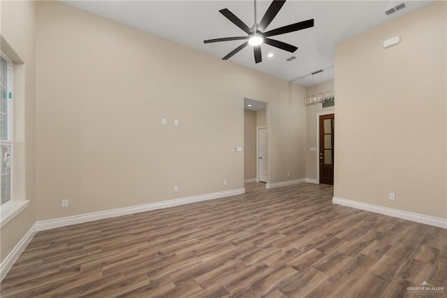 spare room featuring ceiling fan and dark wood-type flooring