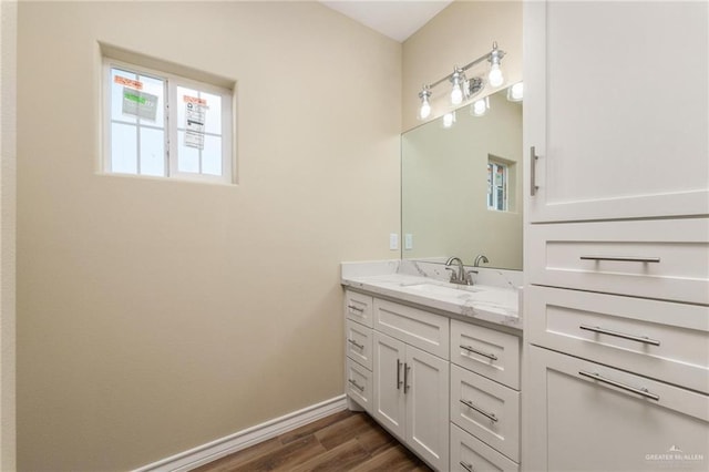 bathroom with vanity, a healthy amount of sunlight, and wood-type flooring