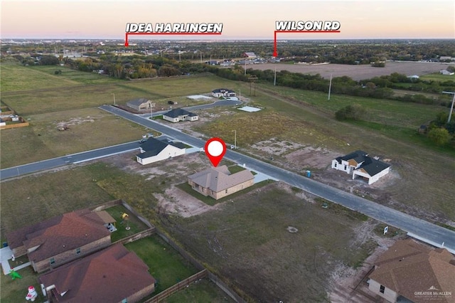 aerial view at dusk featuring a rural view