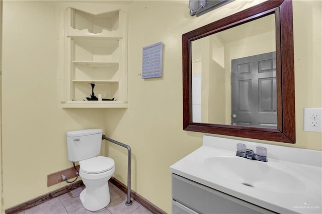 bathroom featuring tile patterned floors, vanity, and toilet