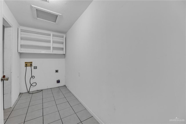 clothes washing area with hookup for a washing machine, light tile patterned floors, and electric dryer hookup