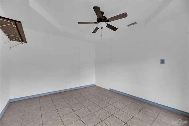 spare room featuring ceiling fan and light tile patterned flooring