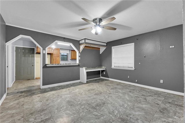 unfurnished living room with ceiling fan