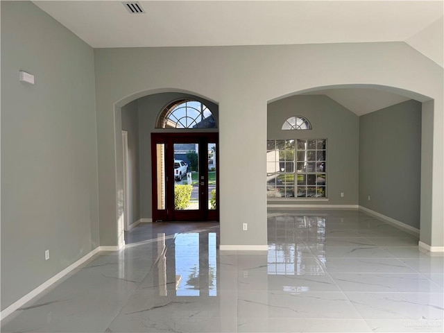 foyer featuring lofted ceiling