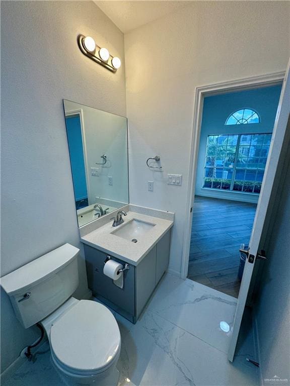 bathroom featuring vanity and toilet