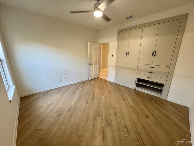 unfurnished bedroom featuring a closet, ceiling fan, and light wood-type flooring