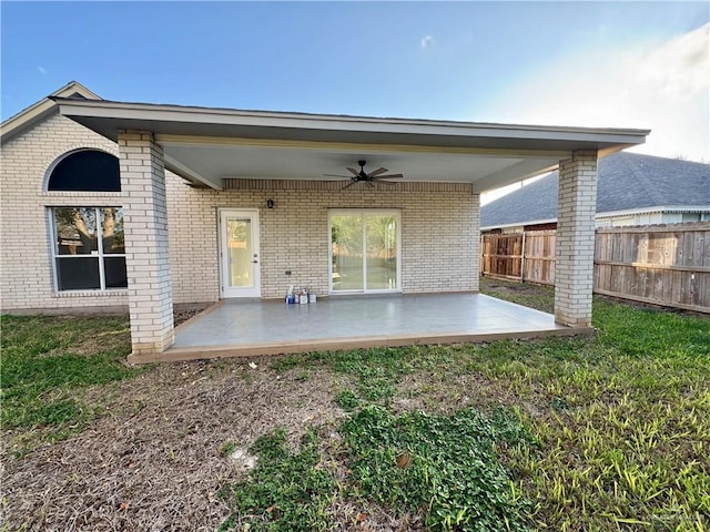 back of property featuring a patio, ceiling fan, and a lawn