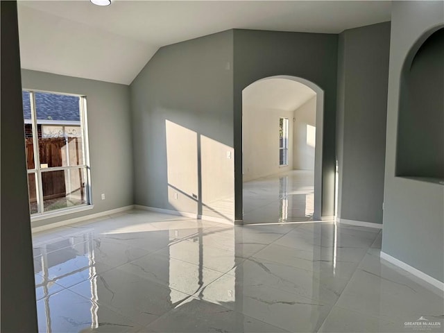 spare room featuring vaulted ceiling