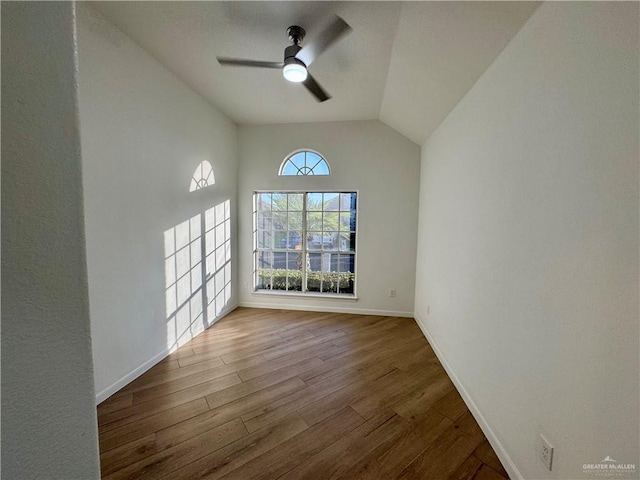 unfurnished room with lofted ceiling, wood-type flooring, and ceiling fan