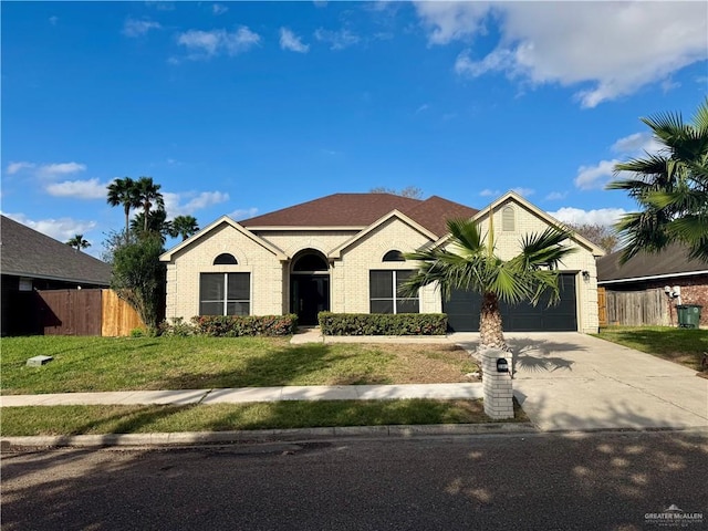 view of front of home with a garage and a front lawn