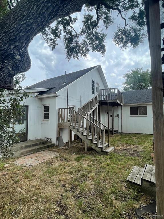 back of house featuring a deck