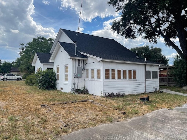 view of property exterior with a yard