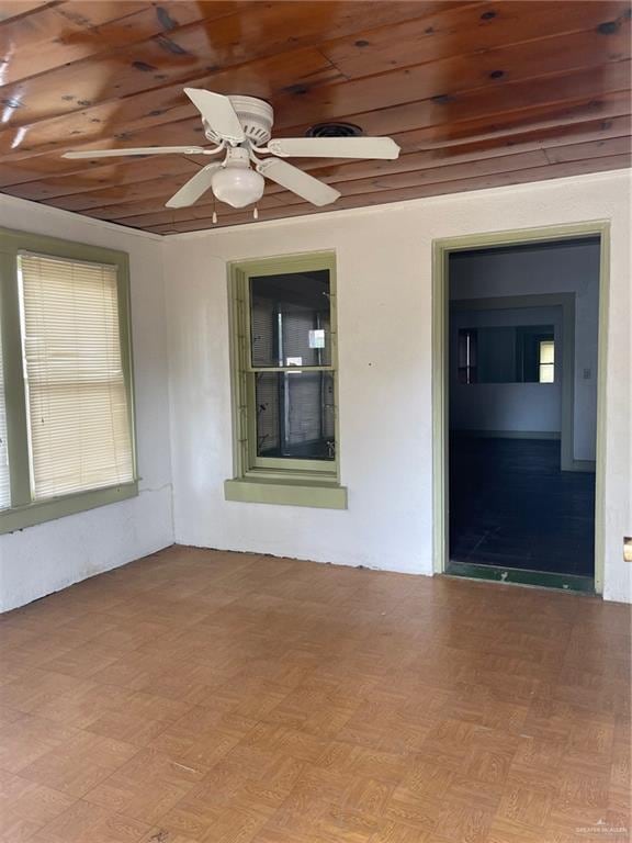 spare room featuring ceiling fan, wood ceiling, and light hardwood / wood-style flooring