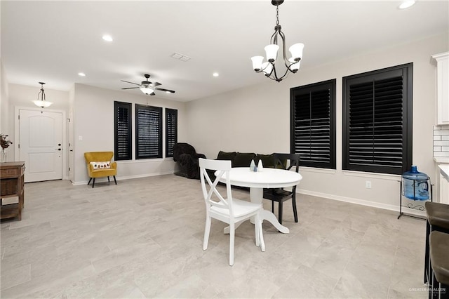 dining room with ceiling fan with notable chandelier