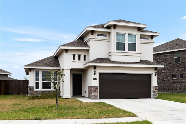 prairie-style home with a garage and a front lawn