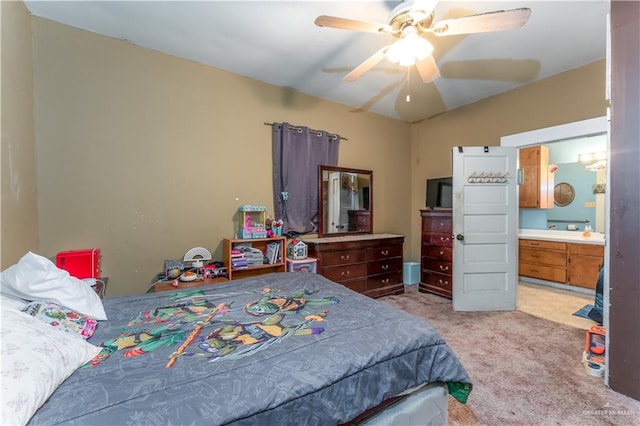 carpeted bedroom featuring ceiling fan and ensuite bathroom