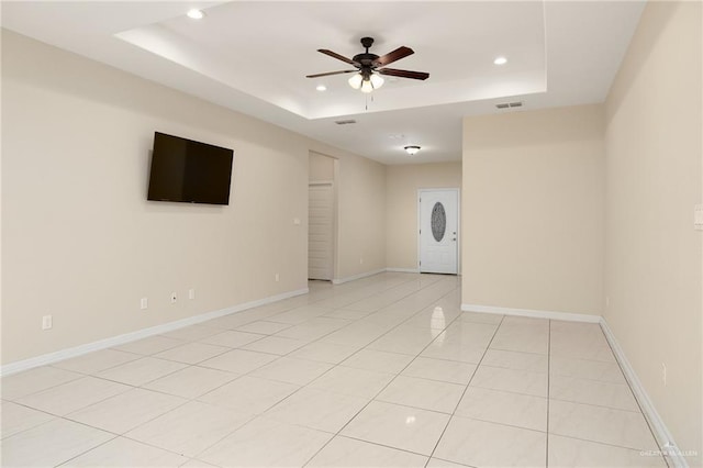 109 Aaron St, Mercedes, TX 78570 - empty room featuring a tray ceiling, a ceiling fan, recessed lighting, light tile patterned floors, and baseboards