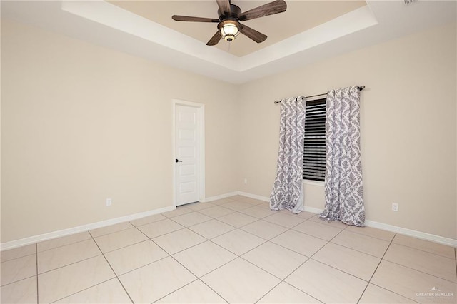109 Aaron St, Mercedes, TX 78570 - empty room featuring a raised ceiling, a ceiling fan, light tile patterned floors, and baseboards