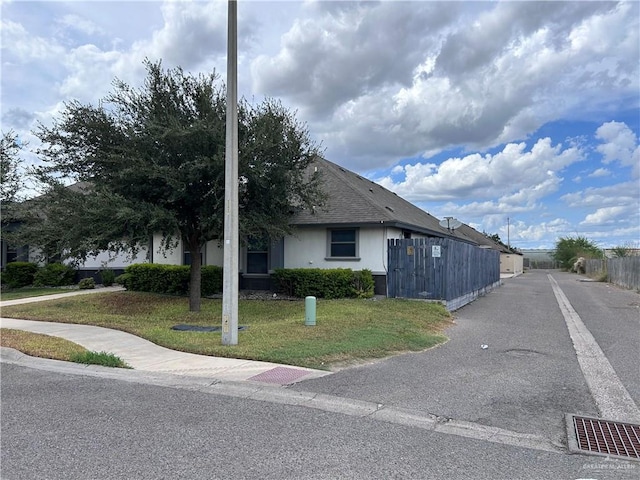 view of property exterior with a yard