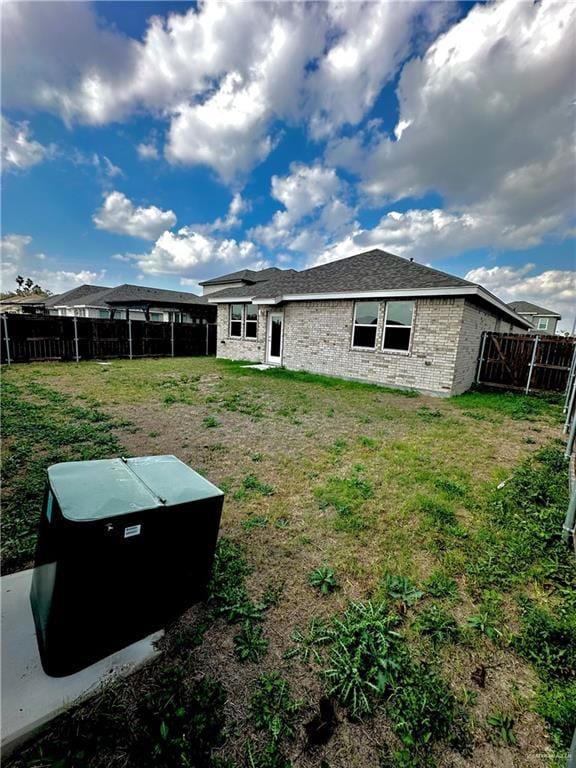 rear view of house with a yard