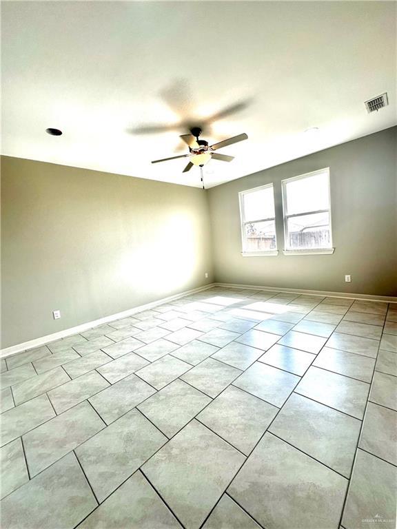 unfurnished room with light tile patterned flooring and ceiling fan